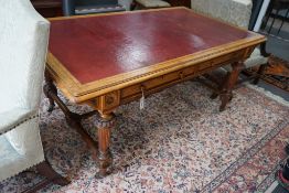 A late Victorian Holland & Sons banded satinwood two drawer library table, retailed by S & H Jewell,