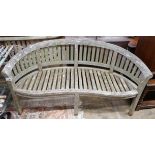 A weathered teak garden banana bench, length 160cm, depth 50cm, height 85cm