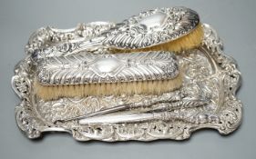 A late Victorian repousse silver dressing table tray, Birmingham, 1898, 30.5cm, together with tow