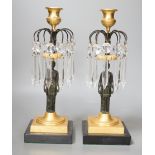 A pair of figural lustre drop candlesticks - 29cm tall
