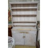 A Victorian painted pine dresser with later boarded rack, length 125cm, depth 42cm, height 215cm