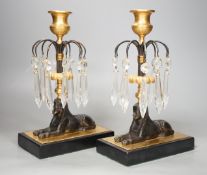 A pair of lustre drop 'sphinx' candlesticks - 23cm tall