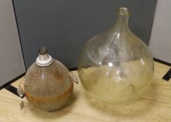 A large clear glass carboy and unusual wire-mounted glass carboy,largest 28cms high.