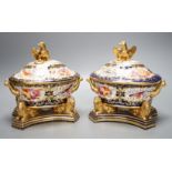 A pair of unusual English porcelain Imari sauce tureens, covers and stands, possibly Coalport c.