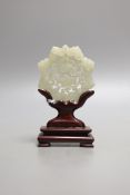 A Chinese pale celadon jade star shaped plaque, wood stand, 12cm