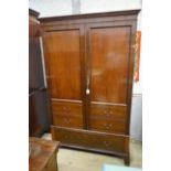 A 1920's mahogany press cupboard with part dummy drawer front over a single drawer, width 120cm,