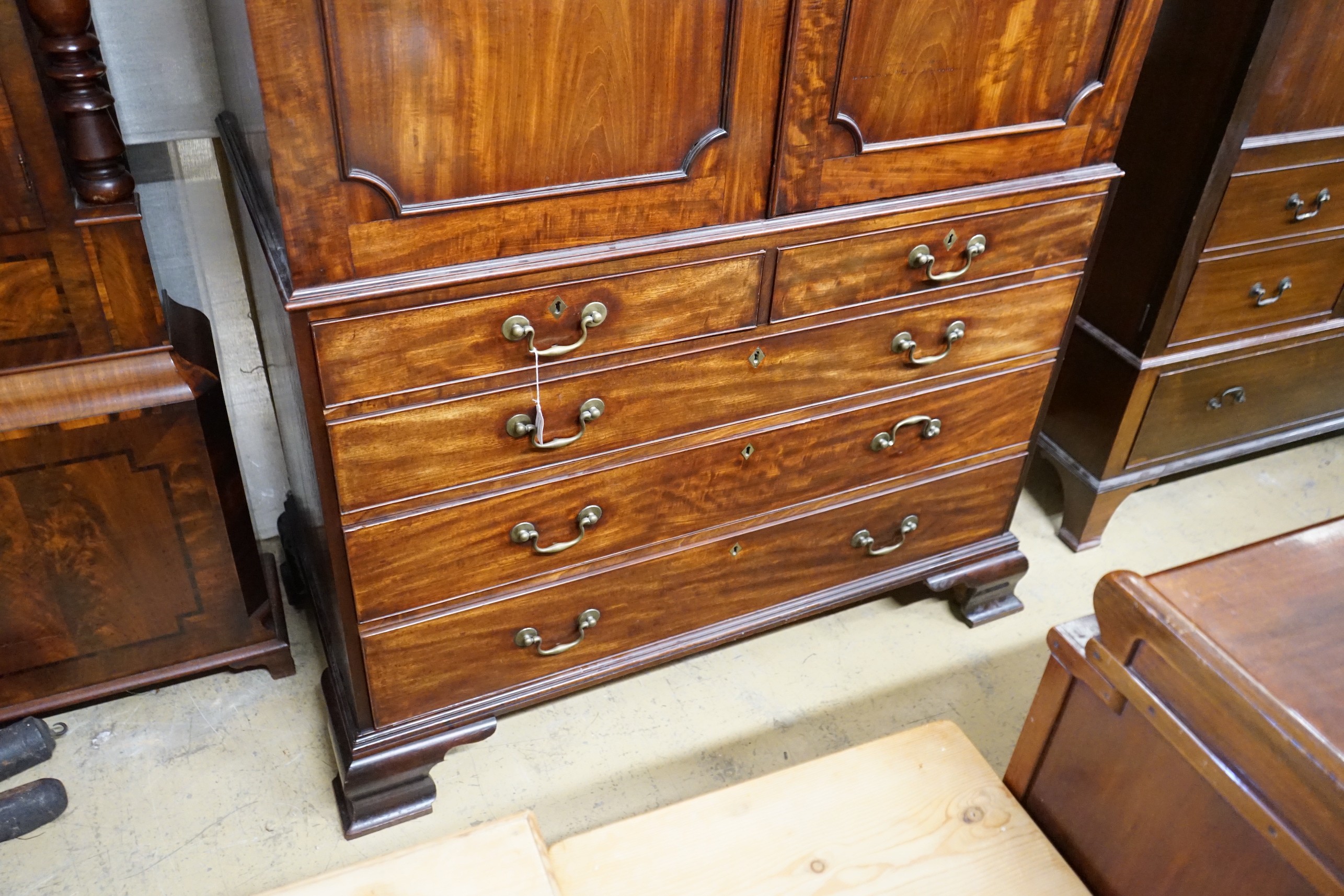 A George III flamed mahogany linen press with broken arch pediment, interior adapted, width 64cm, - Image 2 of 3