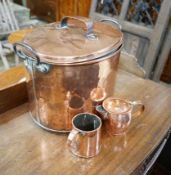A Victorian oval copper lidded cauldron, height 33cm together with a Victorian copper measure and