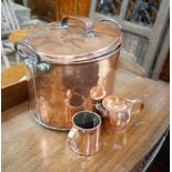 A Victorian oval copper lidded cauldron, height 33cm together with a Victorian copper measure and