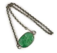 A Chinese jadeite pendant, carved with a bat and twin fruit, the stone of emerald green tone,
