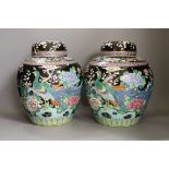 A pair of Japanese famille noire jars and covers, early 20th century, 27cm