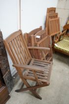 Five assorted teak folding garden chairs