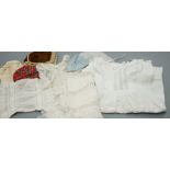 Assorted white cotton dolls dresses, petticoats, one coat and three hats and a child's shoe