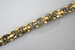 A modern yellow metal, multi green stone and multi diamond chip set bracelet, 16.5cm, gross weight