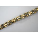 A modern yellow metal, multi green stone and multi diamond chip set bracelet, 16.5cm, gross weight