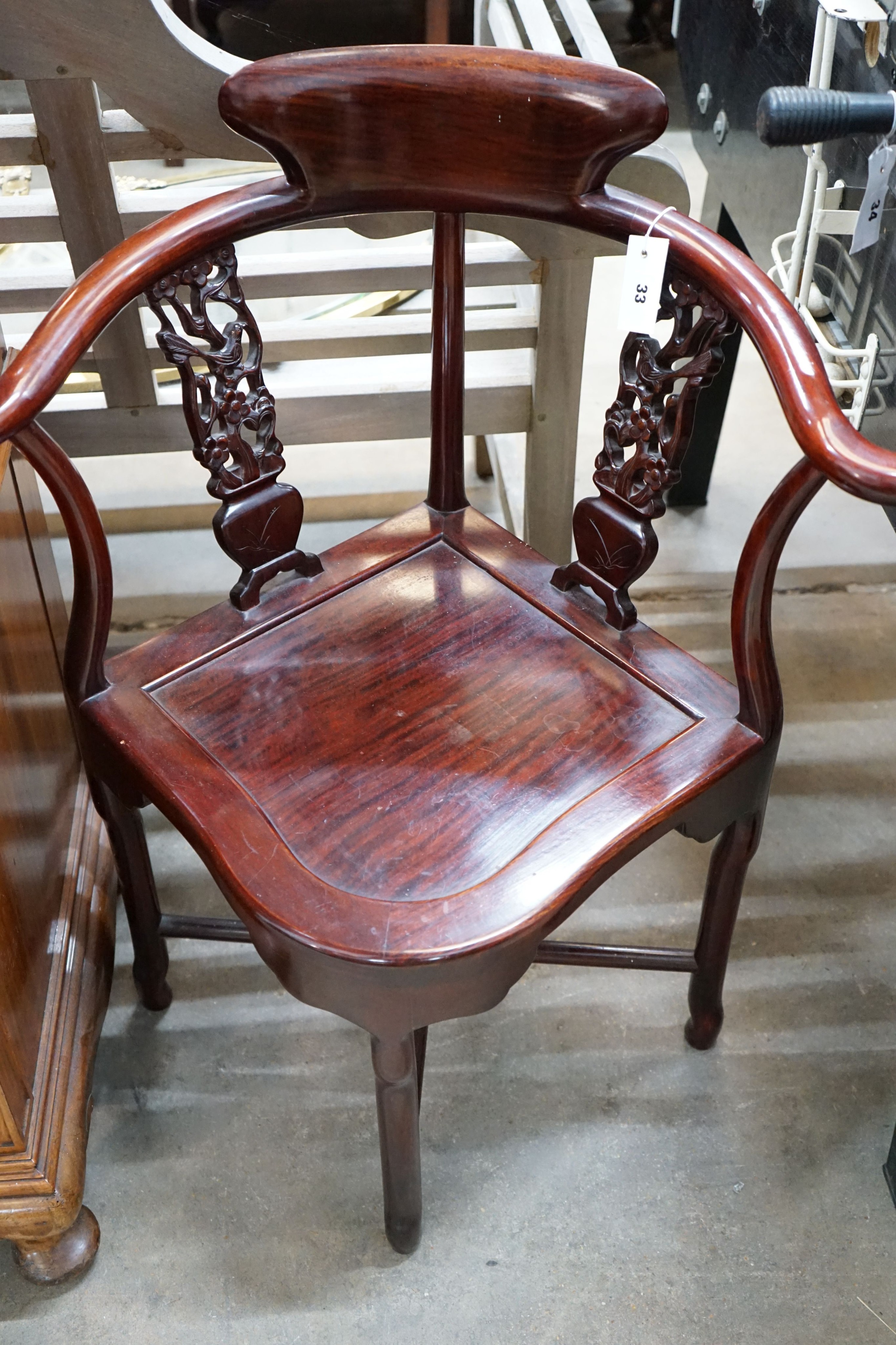 A Chinese carved corner elbow chair, width 69cm, depth 54cm, height 86cm