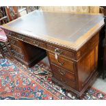 A reproduction Georgian style mahogany twin pedestal desk, fitted nine short drawers, on plinth