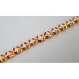 A modern Thai yellow metal and pink gem set cluster bracelet, 17cm, gross weight 8.7 grams.