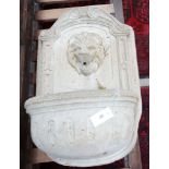 A reconstituted stone garden fountain with lion mask spout, height 75cm