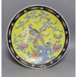 An early 20th century Japanese yellow ground dish with bird and floral decoration - 36.5cm diameter