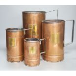 A graduated set of four copper and brass grain measures,tallest 39.5 cms high.