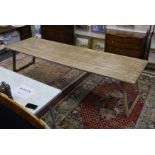 A large French rectangular pine and wrought iron folding trestle table, length 300cm, depth 91cm,