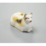 A rare Staffordshire porcelain figure of a recumbent cat, c.1835-50, with impossibly long tail, 6 cm