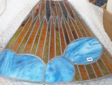 A set of four Deco style fan shaped stained glass panels