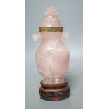 A late 19th/early 20th century Chinese carved rose quartz vase and cover, on a Hongmu stand,23.5