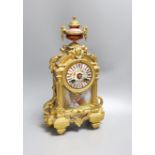 A French gilt spelter mantel clock, with porcelain figurative cartouche and enamelled dial,37 cms