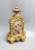 A French gilt spelter mantel clock, with porcelain figurative cartouche and enamelled dial,37 cms