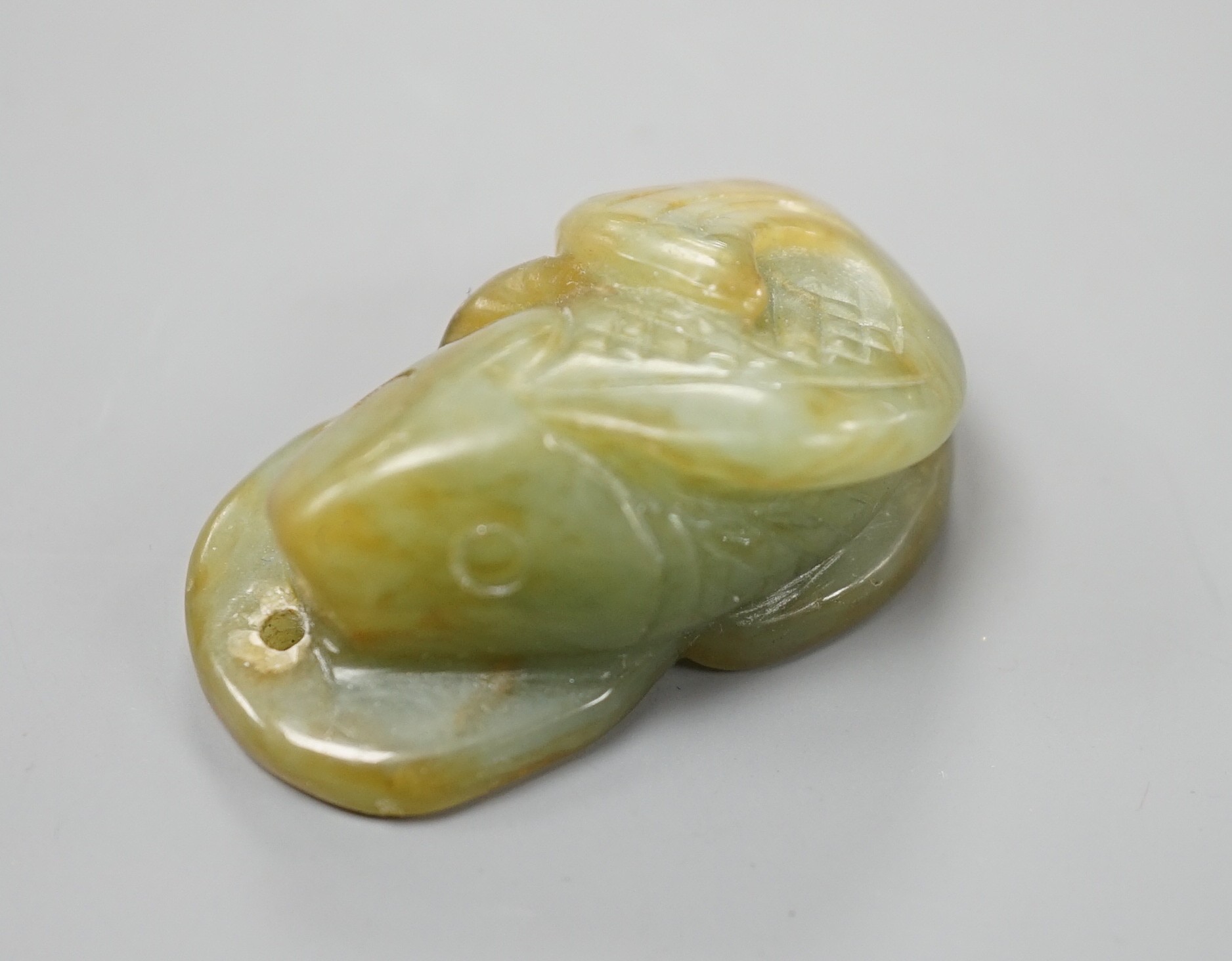 A Chinese jade fish and cash pendant, 3.4cm