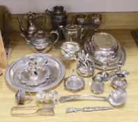 A quantity of assorted plated wares including a chamberstick, a tea set, flatware, a cocktail