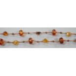 A single strand facetted and pebble amber necklace, 138cm.