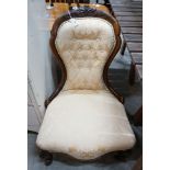 A Victorian walnut upholstered spoon back nursing chair