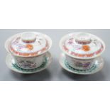 A pair of Chinese famille rose bowls, covers and stands painted with the 8 Buddhist emblems, 9cm