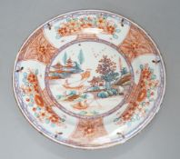 An 18th century Chinese clobbered plate,23 cms diameter.