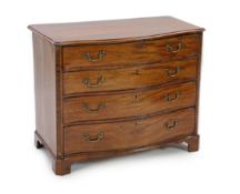 A George III mahogany serpentine dressing chest, with straight sides and fitted four graduated