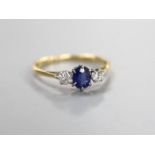 An 18ct & plat, sapphire and diamond set three stone ring, size O, gross weight 2 grams.