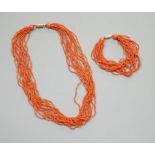 A multi strand coral bead necklace, 39cm and matching bracelet, 15.5cm, both with yellow metal