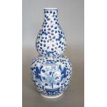 A Chinese double gourd blue and white vase,27 cms high.