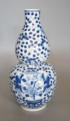 A Chinese double gourd blue and white vase,27 cms high.