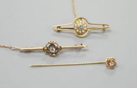 An early 20th century yellow metal and single stone diamond set bar brooch, 46mm, one other gem
