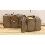 Two 1980's soft canvas Dunhill suit cases,largest 65 cms wide x 42 ms high.