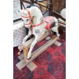 An Ayres type dappled rocking horse on pine safety frame, length 135cm