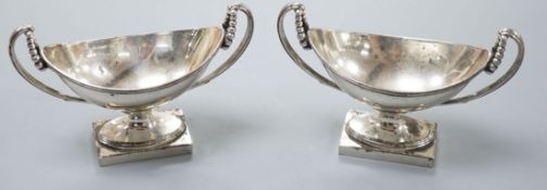 A pair of George III silver boat shaped two handled pedestal salts, Peter Podio, London, 1798, width