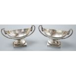 A pair of George III silver boat shaped two handled pedestal salts, Peter Podio, London, 1798, width