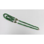 A 20th century Chinese single/double strand malachite bead necklace, with white metal clasp and