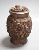 A Burmese carved wooden tobacco jar and cover - 17cm tall