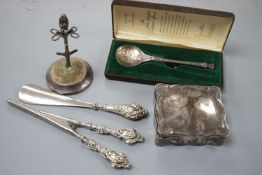 A George V silver mounted hat pin stand, two silver spoons, a silver mounted trinket box, a pair